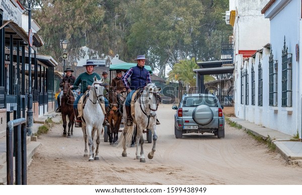 Horse riders, El\
Rocio, Spain - February 24, 2018: pilgrims in famous western themed\
town Southern Spain 