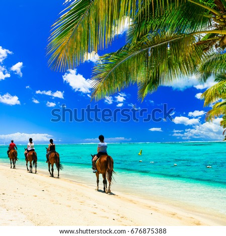 Horse riding on tropical beach. Mauritius island
