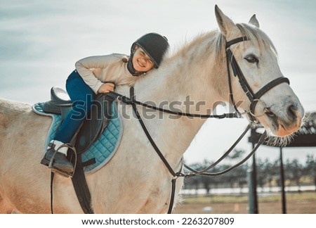.Horse riding, young equestrian and portrait of a girl on a animal in the countryside. Farm, summer and horses training outdoor on farming field with a happy kid smile learning to ride for sport.