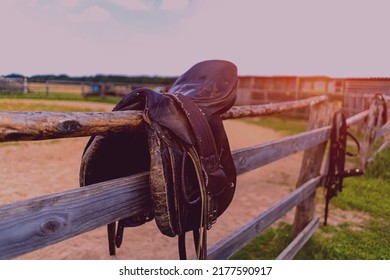 Horse Saddle Hanging On A Fence Close-up