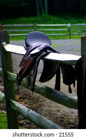 Horse saddle over a fence rail