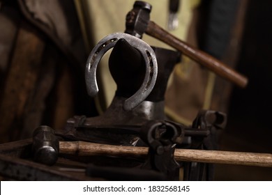 Horse shoe and hammers on anvil blacksmith shop