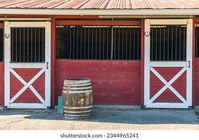 A horse stable with red and white gates - Powered by Shutterstock