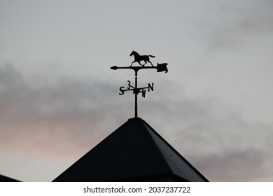 Horse themed weathervane barn cupola compass cloudy background aesthetically pleasing