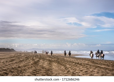 Horse Trek Event Along A Beach In Remote Northland Of New Zealand 