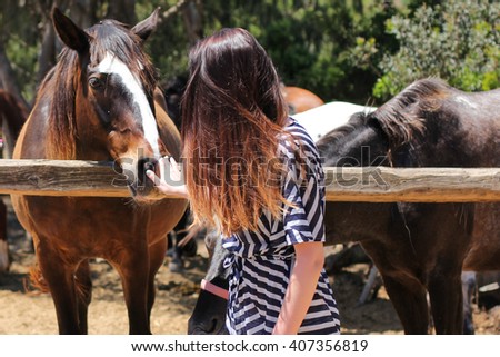 Horse and woman with long hair.