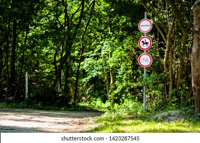 Horseback riding and bicycles forbidden red sign next to a hiking trail in the forrest - Shutterstock ID 1423287545