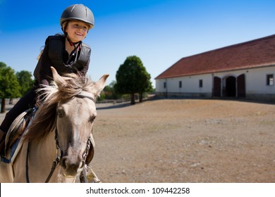 Horseback riding, lovely equestrian - little girl is riding a horse - Powered by Shutterstock