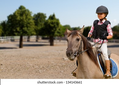 Horseback riding, lovely equestrian - little girl is riding a horse - Powered by Shutterstock