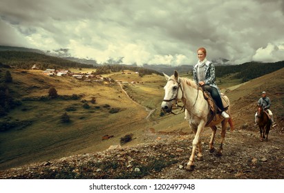 Horseback Riding On The Background Of The Mountain Village Of Shenako In The Province Of Tushetiya, Georgia