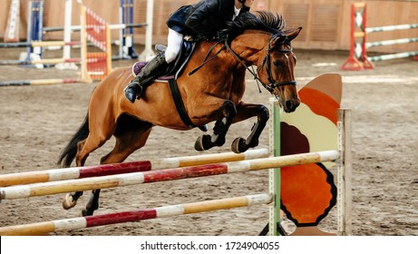 horseman on horse jumping obstacle in competition equestrian sport