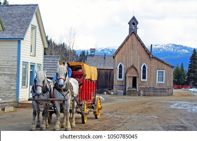 Horses pulling old wagon in historic town of Barkerville, British Columbia Canada