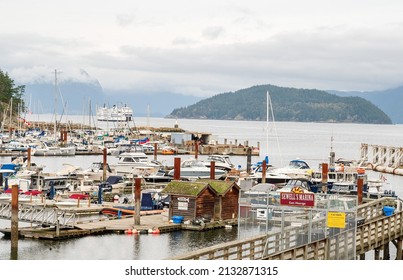 Horseshoe Bay BC, Canada - October 17, 2020:  The Horseshoe Bay to Nanaimo BC ferry sailing into the ferry terminal at SewellÕs Marina.  West Vancouver, BC, Canada.
