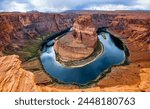 Horseshoe Bend is a horseshoe-shaped incised meander of Colorado River near Page, Arizona, USA and part of Grand Canyon. Panoramic wide angle view of river loop and colorful red sandstone. Major sight