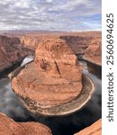 Horseshoe Bend is a mesmerizing natural wonder where the Colorado River makes a dramatic, horseshoe-shaped curve through vibrant red sandstone cliffs. Standing at the edge of the overlook, you’re gree