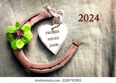Horseshoe four leaf clover heart with  text in german Frohes Neues Jahr und Zahl 2024 that means in english  Happy New Year and number 2024