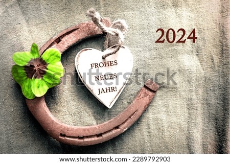 Horseshoe four leaf clover heart with  text in german Frohes Neues Jahr und Zahl 2024 that means in english  Happy New Year and number 2024