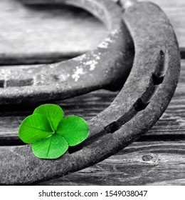 Horseshoe with lucky clover on wood background - Shutterstock ID 1549038047