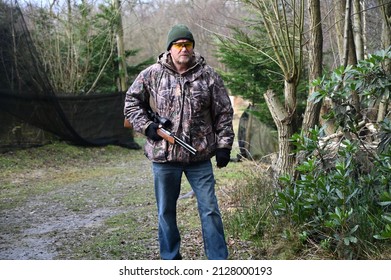 Horsham, West Sussex, UK-February 23 2022: A Hunter With A Hunting Rifle In The UK. 