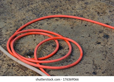 Hose Tangled On Cement Floor