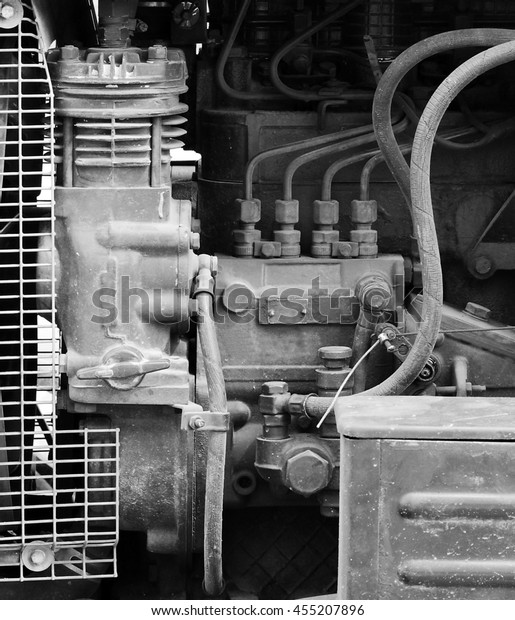 hoses, engine and spare parts inside the\
hood of the tractor, Gatchina, Leningrad\
region