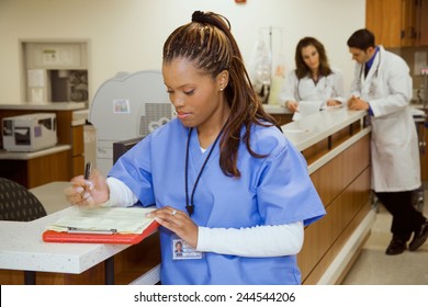 Hospital: African American Nurse At Ward Counter