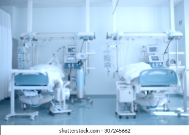Hospital Background. Defocused Image Of A Hospital Ward (ICU) With Patients On Beds