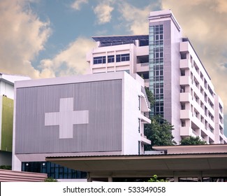 Hospital Building With Big Symbolic At Cloudy Day