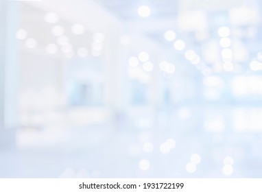 Hospital Building Blur Background With Light Bokeh. Abstract White Empty Hospital Office Corridor Business Hallway In Modern Room Hall Interior With Bright Light Bokeh Blurred Background
