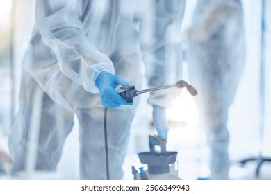 Hospital, cleaning and people with equipment in disinfection for contamination, safety and protocol. Medical service, spray and worker with PPE in ward for healthcare, sanitation or infection control - Powered by Shutterstock