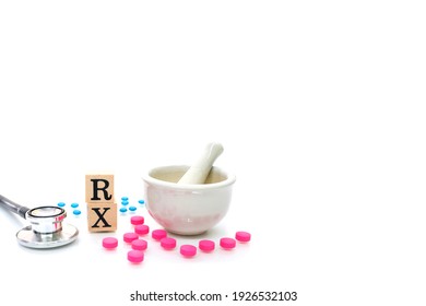Hospital, clinic, healthcare and medical concept. RX with Stethoscope , Mortar and Pestal with pink and blue pills isolated on white background. Mortar and RX symbol using as pharmacy concept.