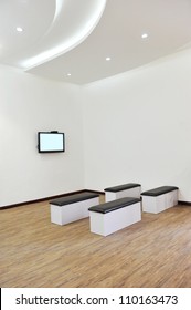 Hospital Or Clinic Waiting Room With Stools And Flat Screen TV.