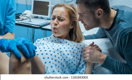 In the Hospital Close-up on Woman in Labor Pushes to Give Birth, Obstetricians Assisting, Husband Holds Her Hand. Modern Delivery Ward with Professional Midwives. - Shutterstock ID 1181843005