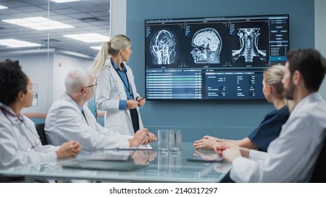 Hospital Conference Meeting Room: Female Neurologist Shows MRI Scan Brain Images on TV Screen, Team of Neuroscientists, Doctors Discuss Patient Treatment, Drug Research, Medicine Development