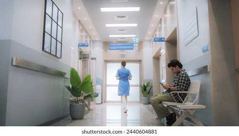 Hospital Corridor with Active Doctors and Nurses Working and Patients and Visitors Waiting. Modern Indian Clinic Providing Different Healthcare Services - Powered by Shutterstock