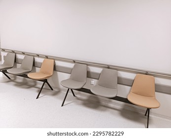 hospital corridor narrow corridor bright floor rooms and gray and orange armchairs wooden blocks