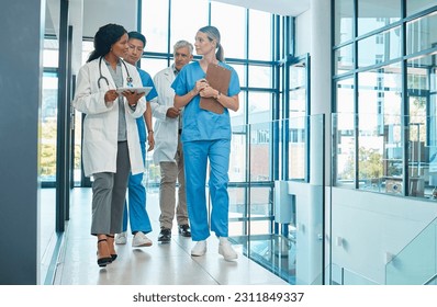 Hospital, doctors and nurses team walking with a tablet for a discussion, planning or research. Diversity men and women healthcare group talking about medical strategy, virus or surgery schedule - Powered by Shutterstock