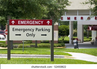 Hospital Emergency Entrance Sign Giving Directions To Emergency Parking