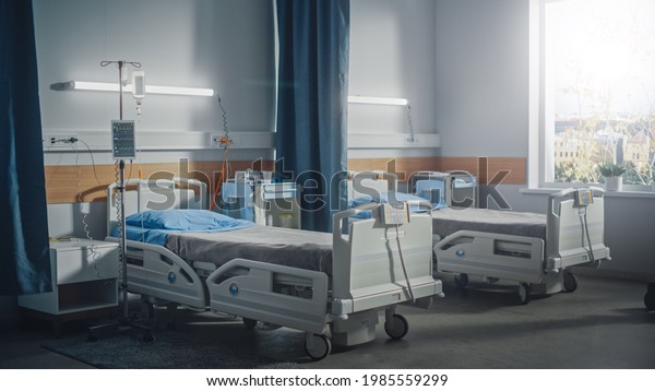 Hospital Intensive Care
Coronavirus Department Ward with Empty Beds. Modern Clinic with
Advanced Equipment, Best Medical Healthy Treatment Center, Bright
Sunny Window View.