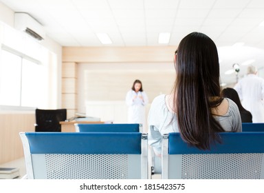 In The Hospital Lobby Room For Medical Checkup, An Asian Female Patient Rests While Waiting In the Reception Queue. Health And Medical Insurance Concept.