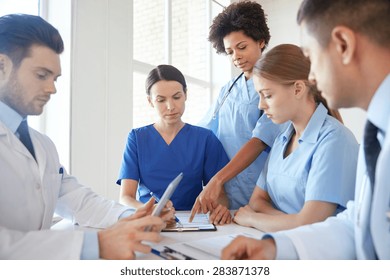 Hospital, Medical Education, Health Care, People And Medicine Concept - Group Of Doctors With Tablet Pc Computers Meeting At Medical Office