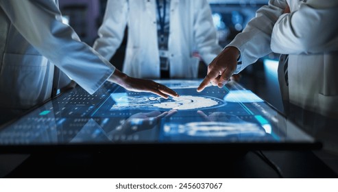 Hospital Medical Research Center: Focus On Hand Gestures Of Diverse Colleagues Gathered Around Interactive Touch Screen Table With MRI Scans Of Brain On Display. Doctors Looking For Alzheimer's Cure. - Powered by Shutterstock