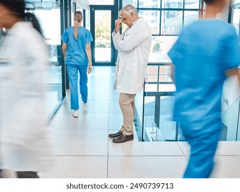 Hospital, motion blur and doctor with headache in stress for medical problem, doubt and bad news. Tired, mature man and frustrated with pain in lobby for healthcare error, fail and mistake in surgery - Powered by Shutterstock