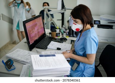 At The Hospital, The Nurse On Duty Makes A Record At The Reception Desk. Busy Modern Hospital With Some Of The Best Specialists And Medicare In The Country.