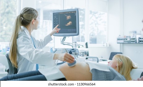 In The Hospital, Obstetrician Uses Transducer For Ultrasound/ Sonogram Screening / Scanning Belly Of The Pregnant Woman And Points Finger At Screen. Screen Shows 3D Image Of The Healthy Forming Baby.