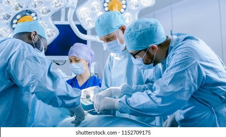 In The Hospital Operating Room Diverse Team Of Professional Surgeons And Nurses Suture Wound After Successful Surgery.