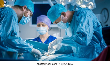 In the Hospital Operating Room Diverse Team of Professional Surgeons and Nurses Suture Wound after Successful Surgery. - Shutterstock ID 1152711362
