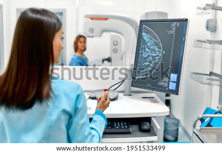 In the hospital, the patient undergoes a screening procedure for a mammogram, which is performed by a mammogram. A modern technologically advanced clinic with professional doctors. [[stock_photo]] © 