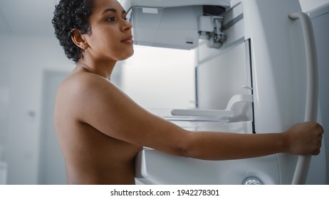 In the Hospital, Portrait Shot of Topless Latin Female Patient with Short Hair Undergoing Mammography Screening Procedure. Healthy Young Female Does Cancer Preventive Mammogram Scan in Radiology Room.