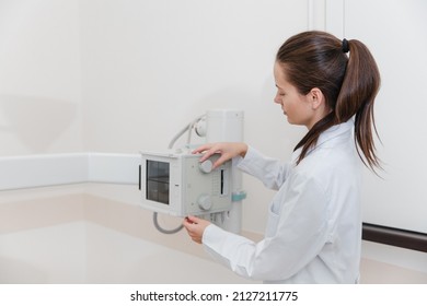 Hospital Radiology Room. Xray Machine For Fluorography. Doctor Radiologist In Gown Adjusting The X-ray Machine For Radiography. Medical Equipment. Scanning Chest, Heart Or Lungs In Clinic Office.